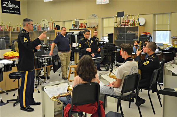 Members of Rustin High School's jazz band receive advice from the US Army Field Band 